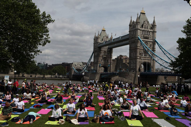 Yoga enthusiasts in London with Tower Bridge in the background